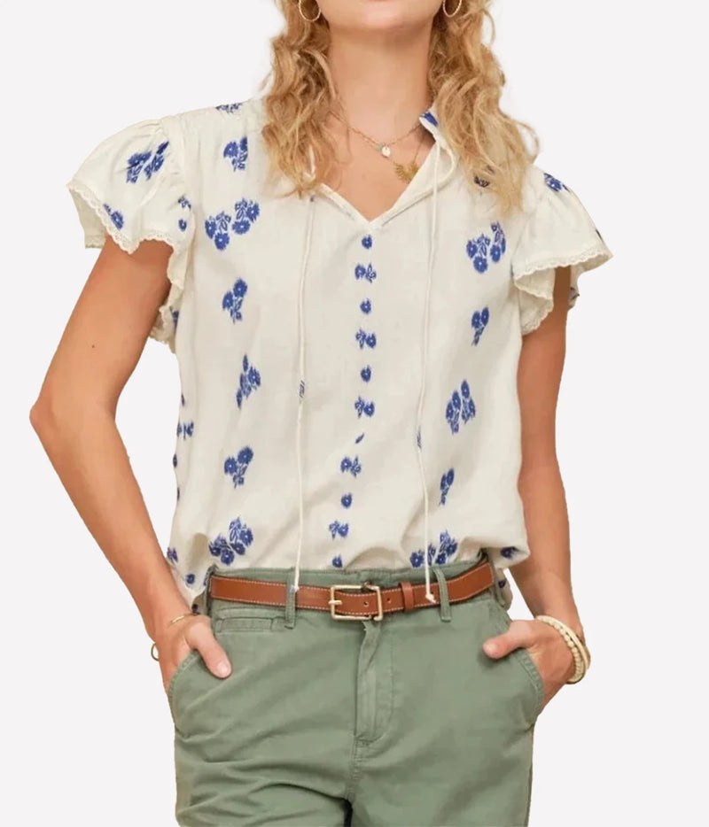 Model wearing the M.A.B.E Iris Woven Frill Short Sleeve Top in Blue – front view