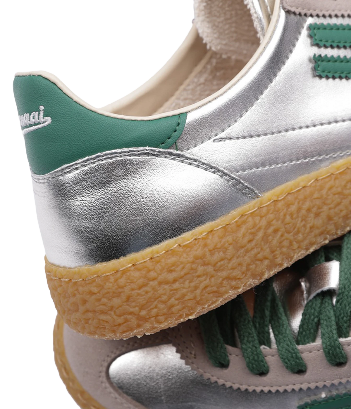 Close-up of the Puraai 6.01 XS Sneaker in Jade, showing the green heel tab with logo, metallic silver vegan leather and textured gum sole