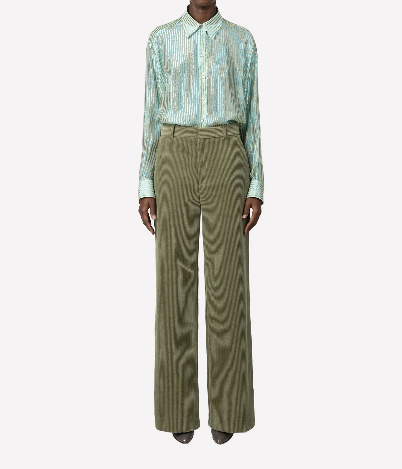A model wearing a mint green striped long-sleeve button-up shirt and olive green wide-leg trousers, shown against a plain light gray background.