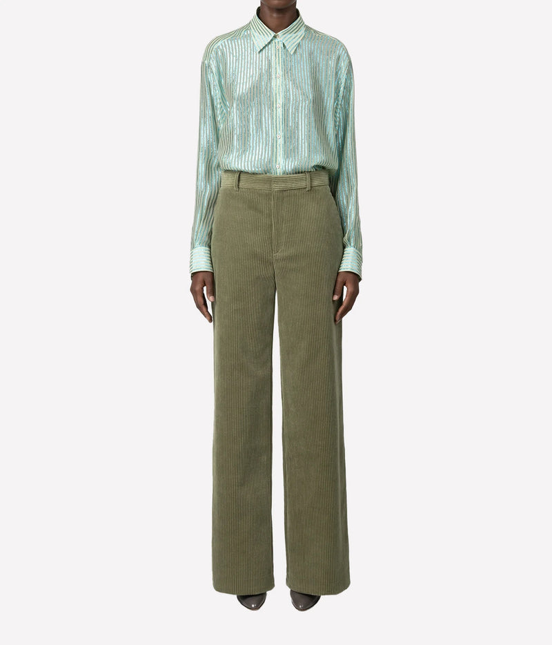 A model wearing a mint green striped long-sleeve button-up shirt and olive green wide-leg trousers, shown against a plain light gray background.