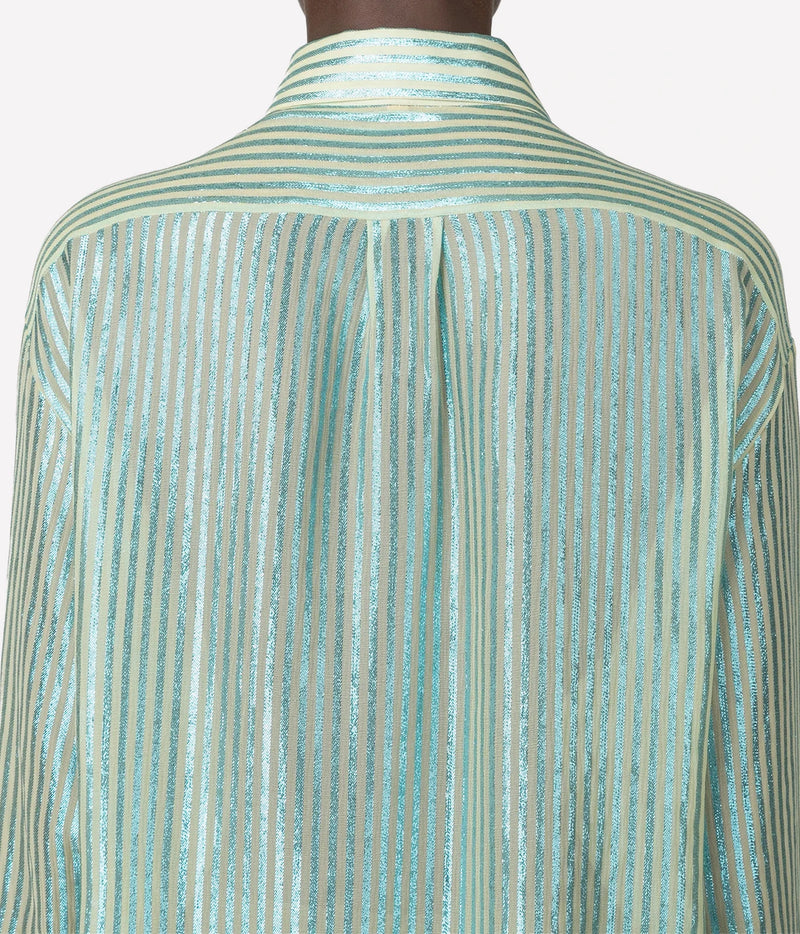 Close-up of the back of a long-sleeve collared shirt with vertical metallic stripes in a pale mint green and silver tone, shown on a mannequin against a light gray background.