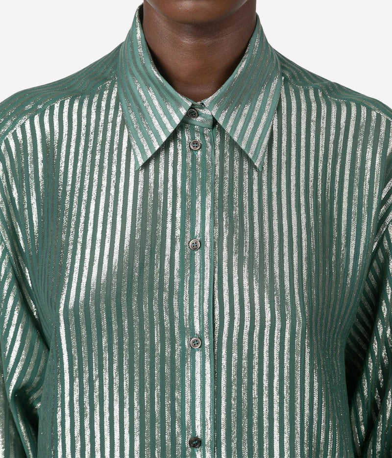 A close-up of a person wearing a collared button-front shirt with vertical metallic-looking stripes in green and white against a light gray background.