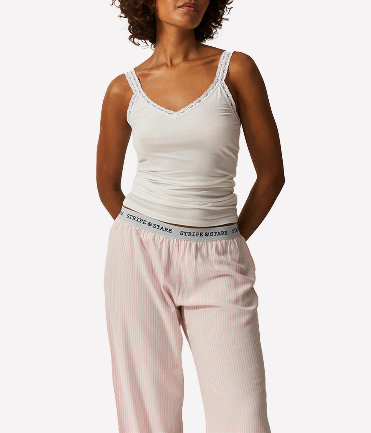 The Lace Cami in White is a versatile and stylish piece perfect for layering or wearing on its own. Crafted from cloud-soft and breathable fabric, it offers exceptional comfort while showcasing a feminine and elegant design. The delicate lace detailing adds a refined touch, making it an ideal choice for both casual and dressy occasions. This cami effortlessly combines comfort with chic style, making it a staple in any wardrobe.