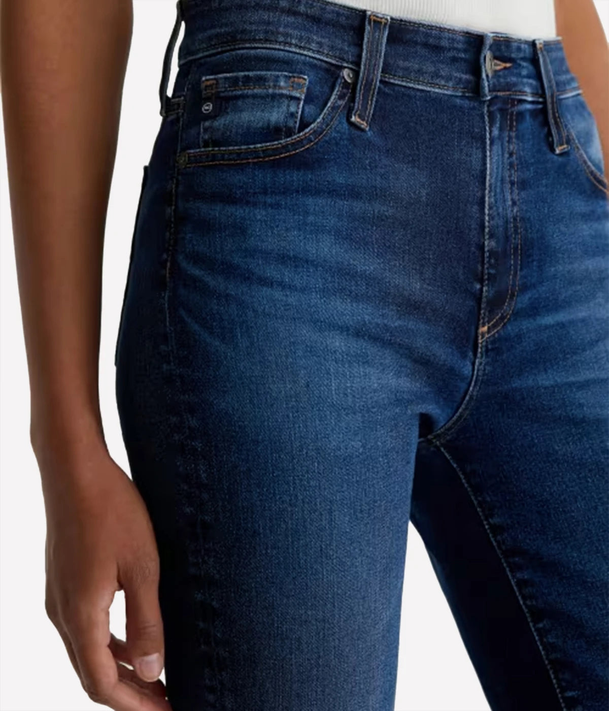 Blue jeans worn by a person on a white background