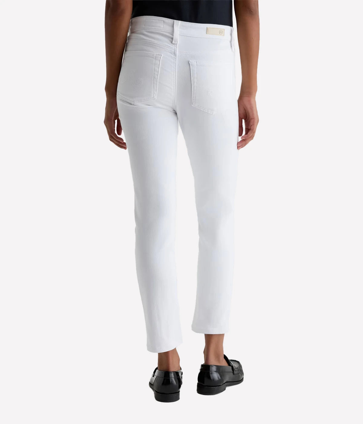 White pants worn by a person on a white background