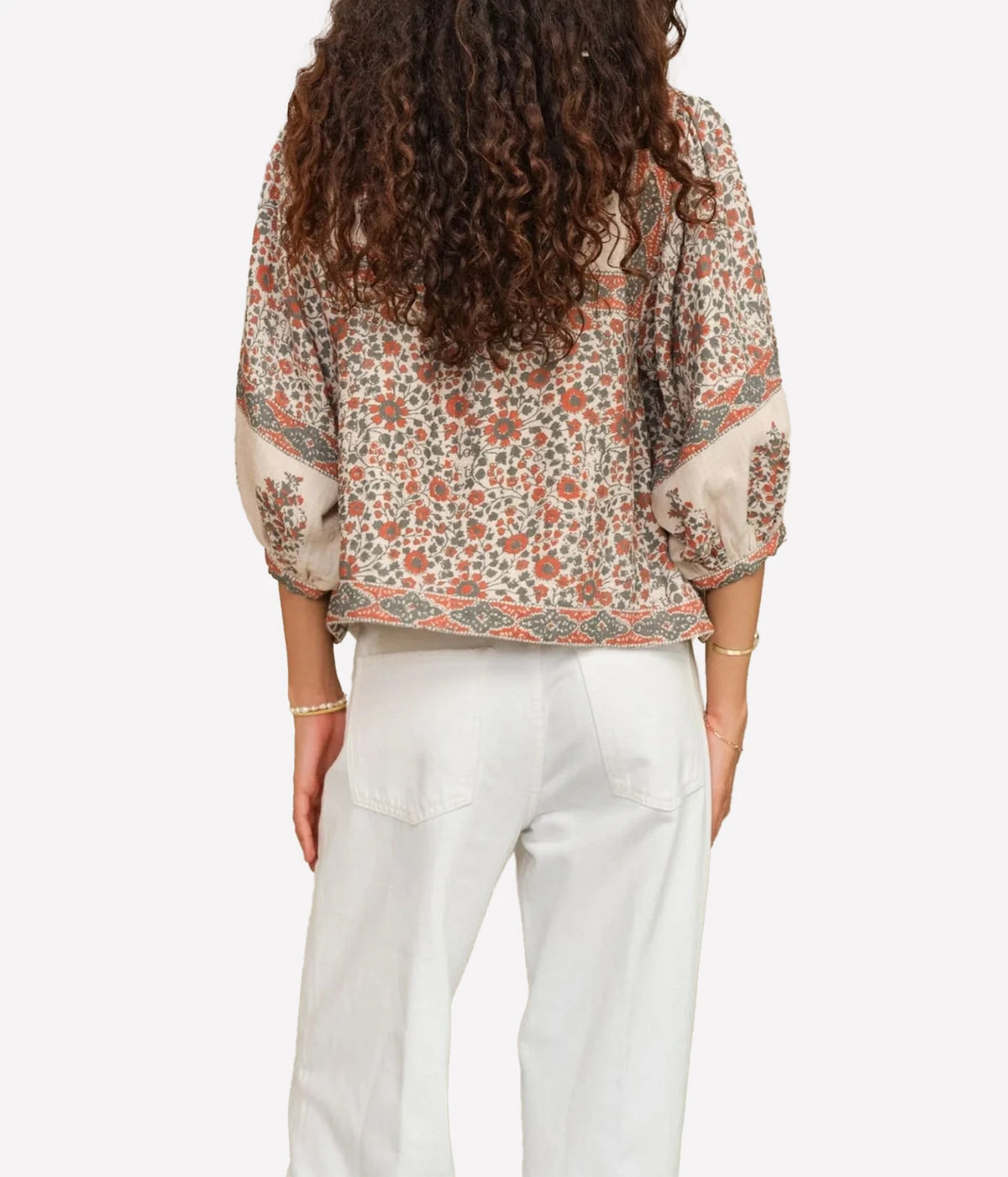 Model wearing the M.A.B.E Della Print Jacket in Rust Khaki with white trousers – back view