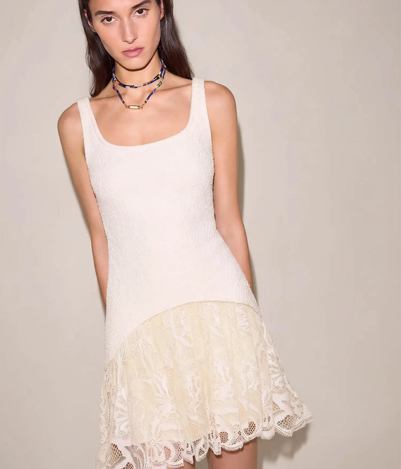 Full front view of a model wearing the Alexis Pomela Mini Dress In Ivory with a dark beaded choker, showing the sleeveless tank-style bodice flowing into the lace mini skirt