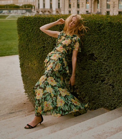 Model walking in the DÔEN Hesperia Dress In Hanbury Garden with black heeled sandals