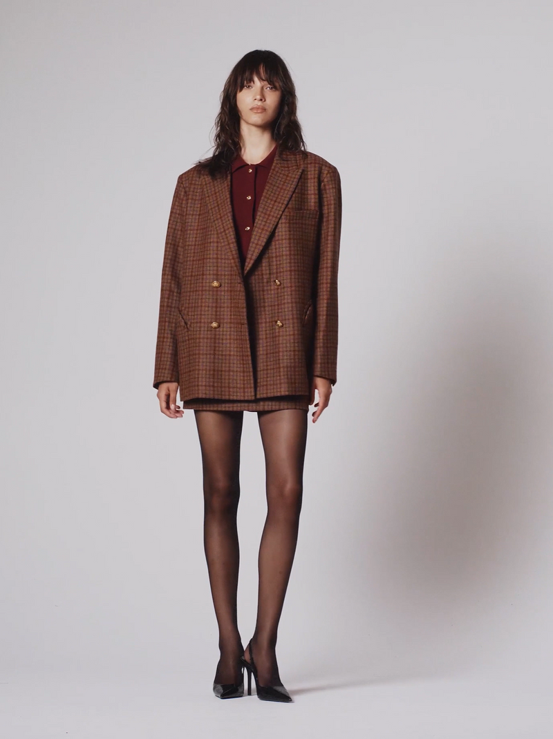 Model wearing the Blazé Milano Nightbreak Blazer in Sweet Sea Brown, an oversized cinnamon check wool blazer with gold-tone buttons and signature Smiley pockets.