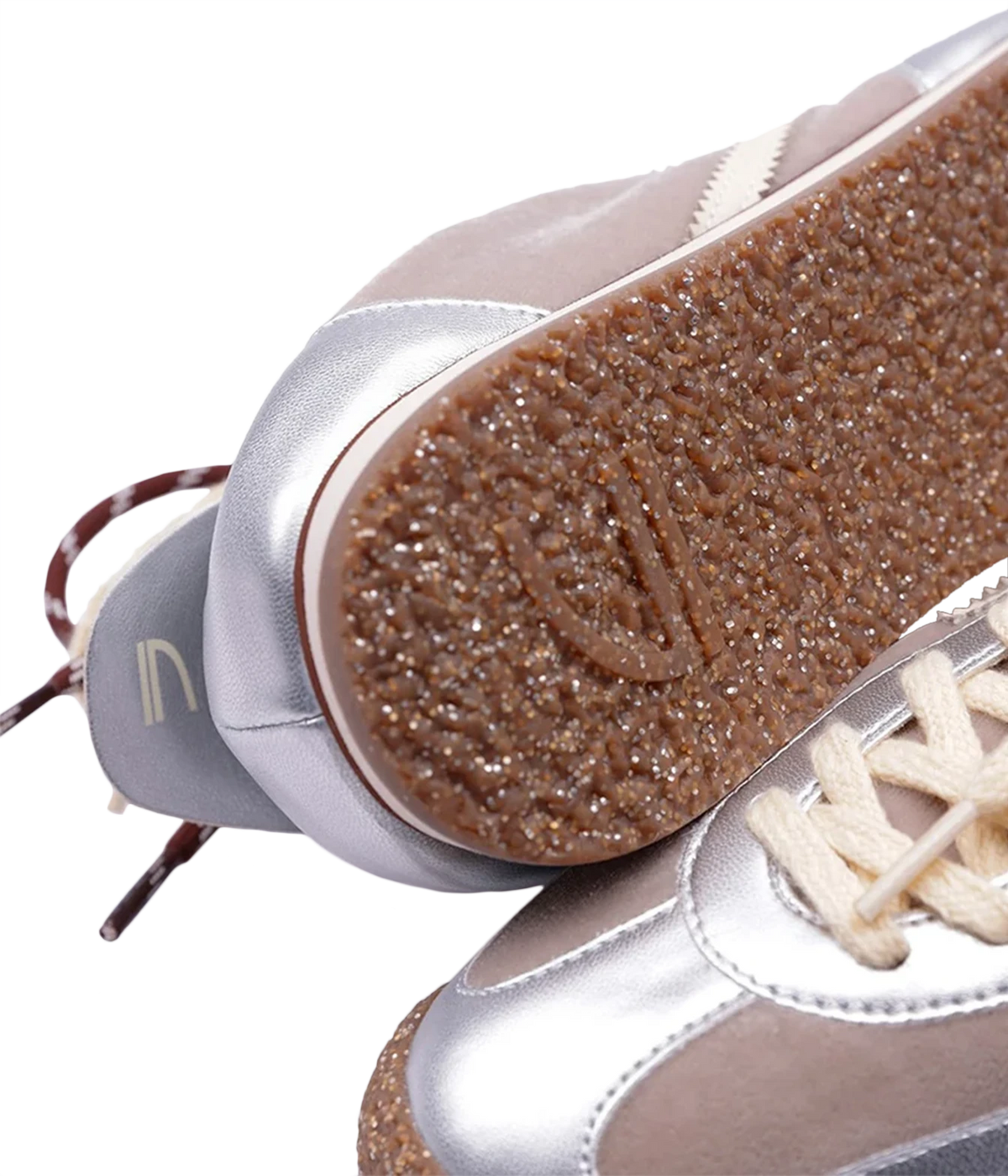Close-up of a pair of low-top sneakers showing the textured brown glittery outsole and metallic silver and taupe panels, Puraai 6.02 Panther Sneaker in Radio