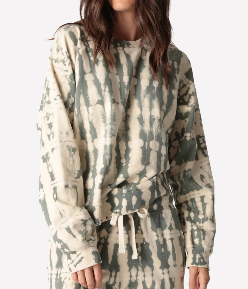 Close-up front view of a model wearing the Electric Rose Ronan Horizon Sweatshirt in Moss Ivory, showing the moss and ivory tie-dye, crew neck and dropped shoulders, with matching tie-dye drawstring joggers
