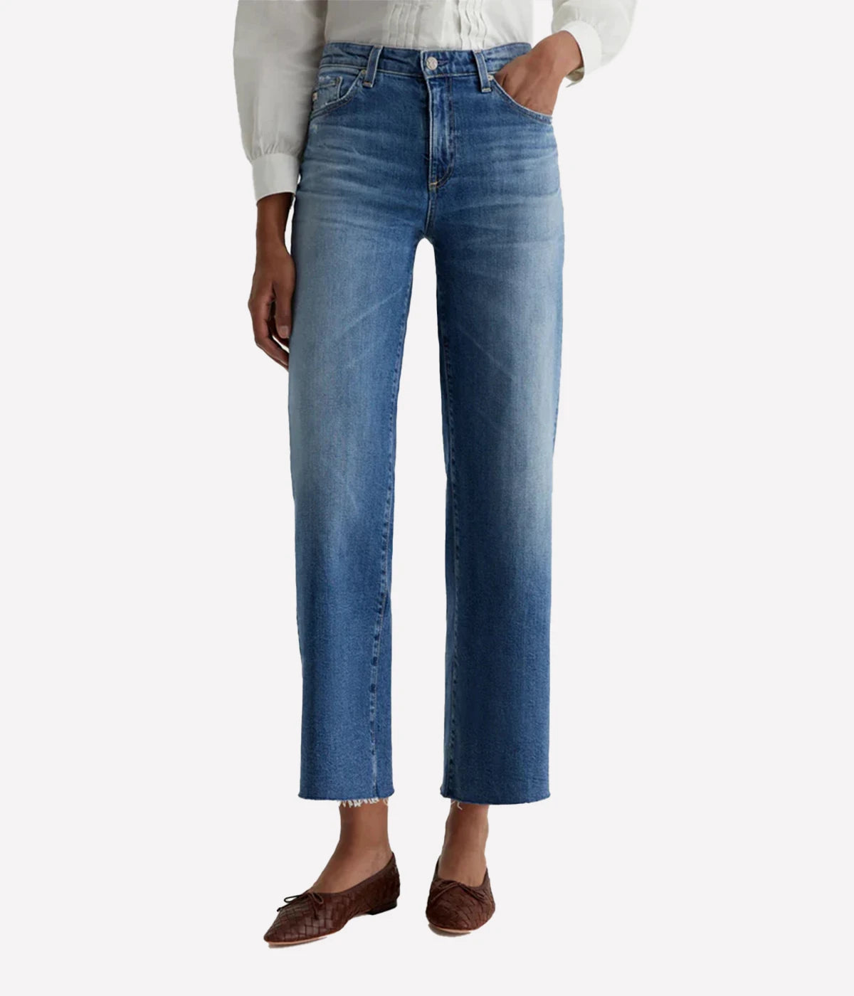 Person wearing blue jeans on a white background