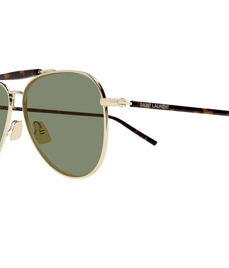 Close-up of Saint Laurent Aviator Sunglasses in Gold focusing on the left green-tinted lens and tortoiseshell temple.