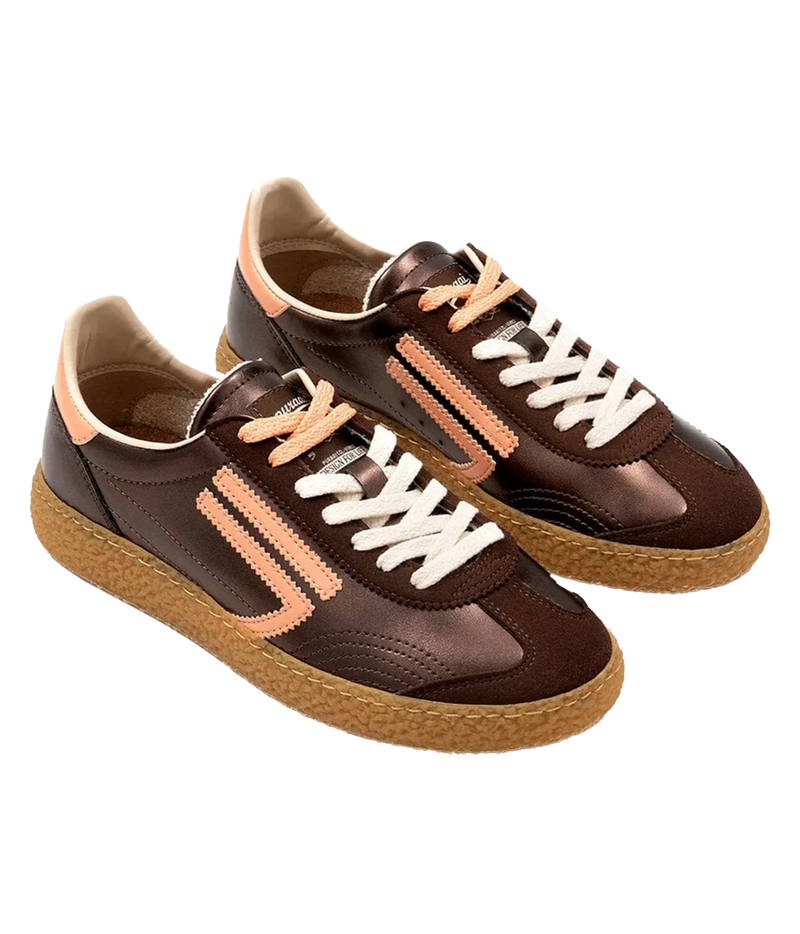 A pair of low-top sneakers in dark brown, featuring peach-coloured side stripes, white laces, and honey coloured soles. 6.01 XS Sneaker in Sandstone Puraai