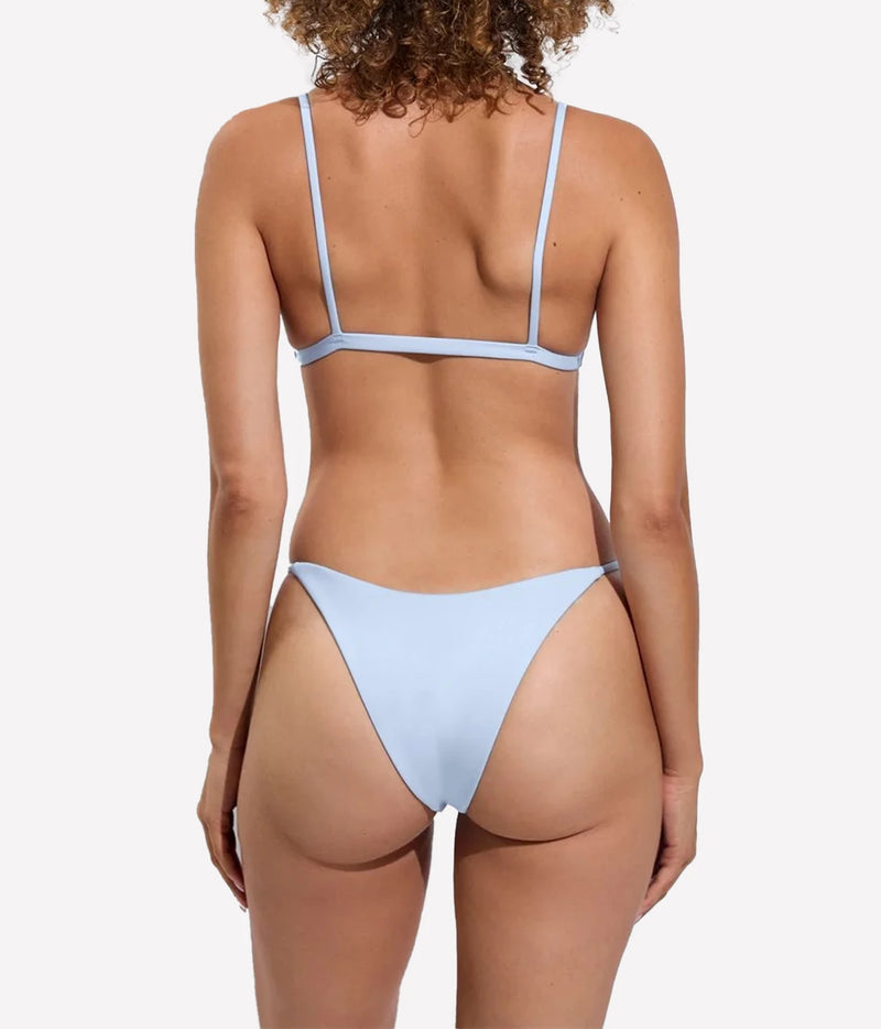 A model shown from the back wearing a bikini set in a sky blue colourway, Sandy Top In Blue Skies