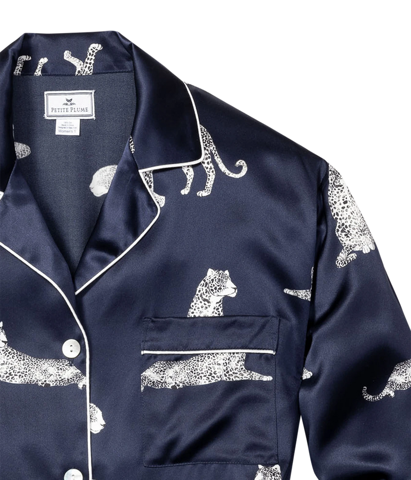 Close-up of the Petite Plume Mulberry Silk Long Pyjama Set in Panthère de Nuit showing the notched collar, white contrast piping, chest pocket and panther print