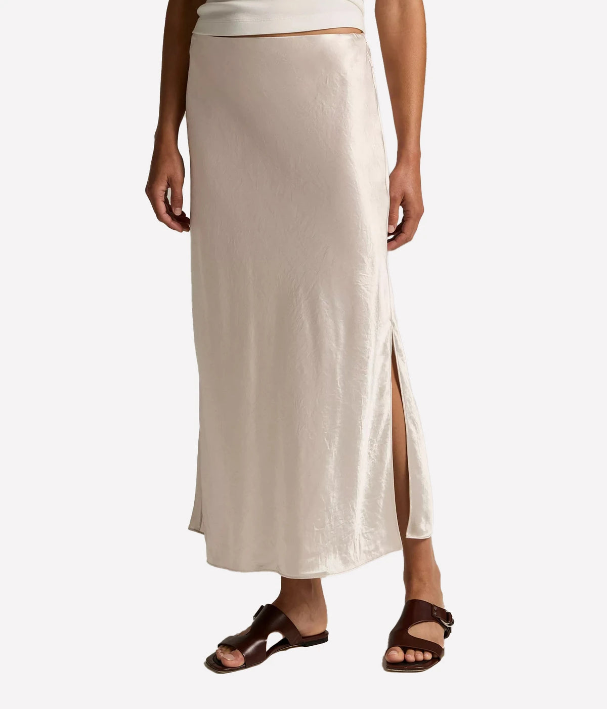 Vince Side Slit Slip Skirt in Champagne, featuring a fluid satin finish and side slit, shown from the front.
