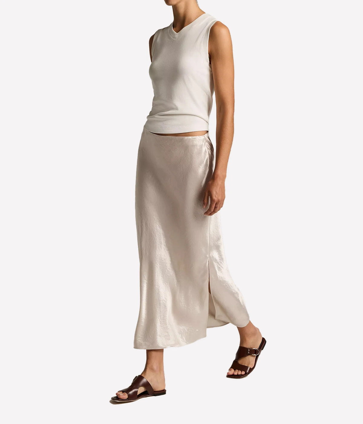 Vince Side Slit Slip Skirt in Champagne, shown in a side view with its flowing midi silhouette and side slit.