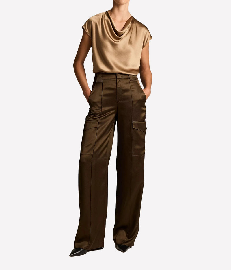 Woman wearing a Carmello cowl neck blouse with brown trousers, full look