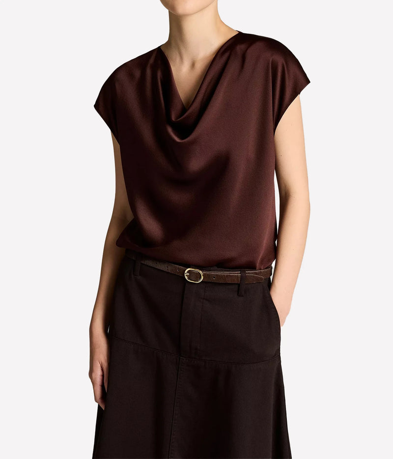 Woman wearing a dark cherrywood cowl neck cap sleeve blouse with trousers
