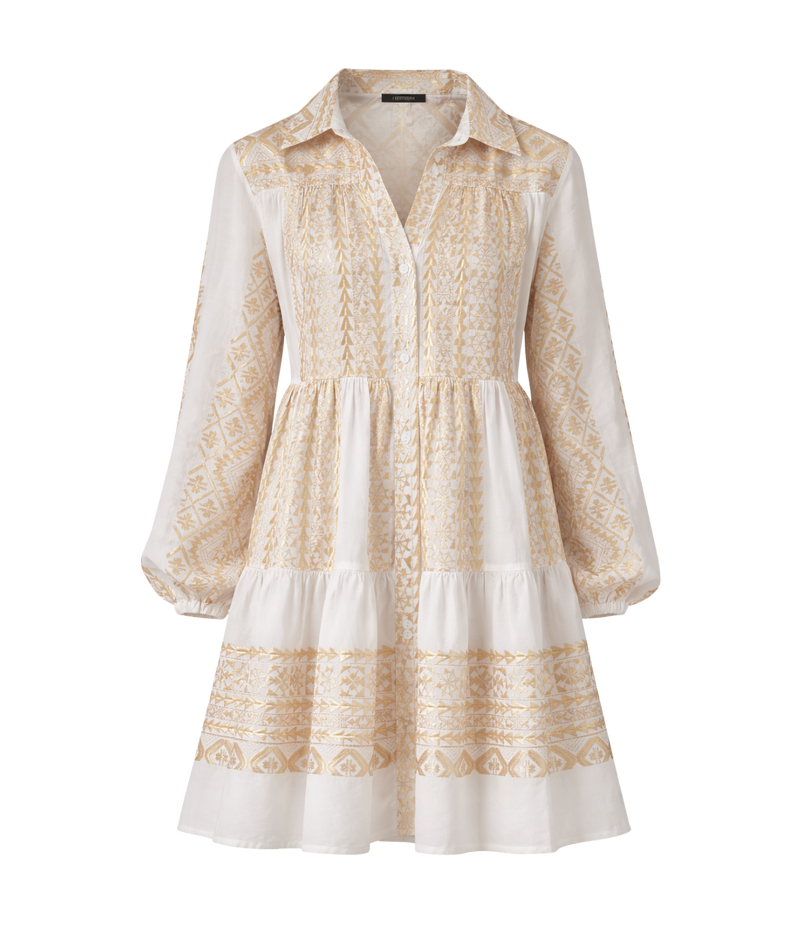 Greek Archaic Kori Short Classic Triangle Balloon Sleeve Shirt In White Gold laid flat, showing the collar, buttoned placket, long balloon sleeves and tiered mini skirt with gold embroidery.