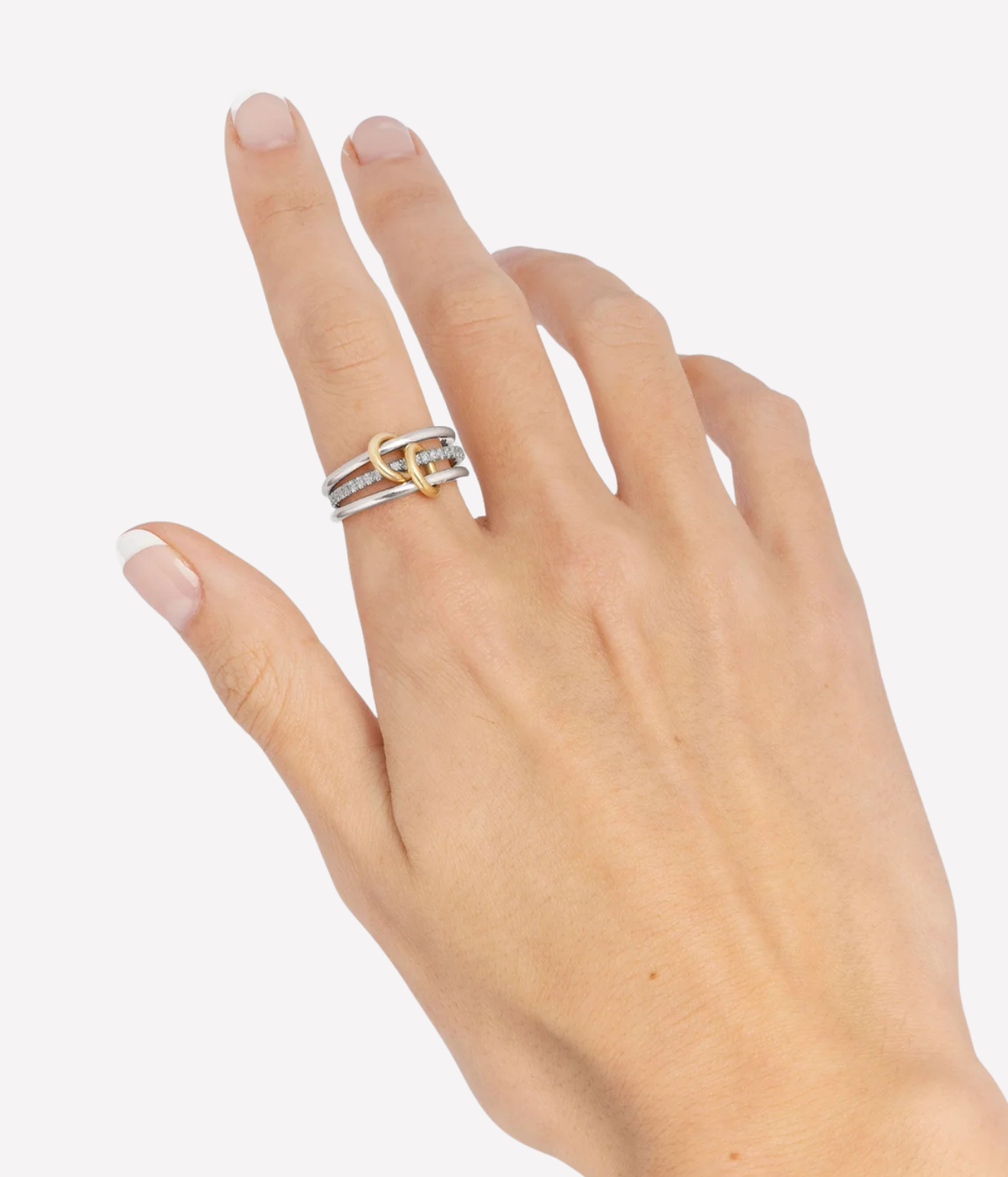 Spinelli Kilcollin Sonny SG Gris Ring worn on a model's raised hand, showing the stacked silver and gold bands from the side