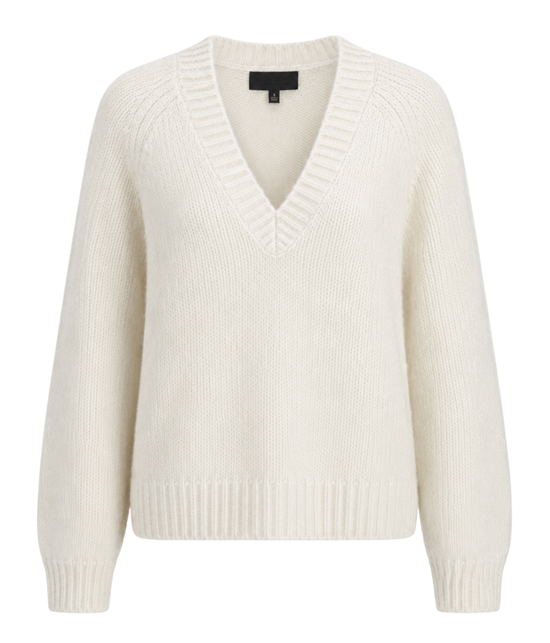 Nili Lotan Isley Sweater In Ivory, laid flat, showing the wide V-neckline, raglan sleeves and ribbed trims