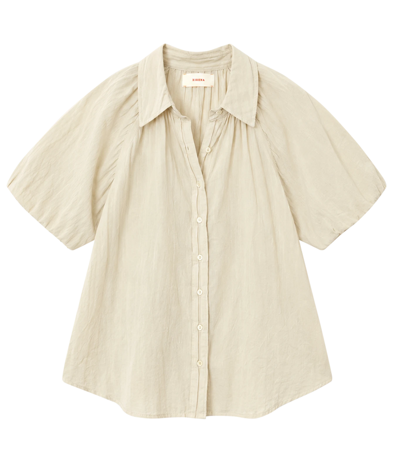 Xirena Lyla Shirt in Parchment laid flat, showing the point collar, button front and short balloon sleeves
