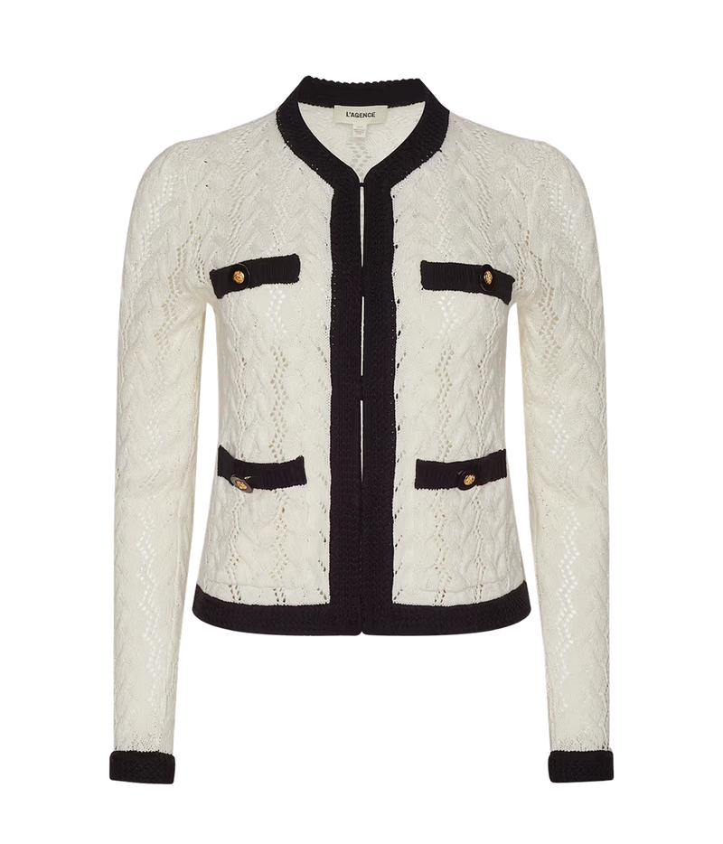 The L'AGENCE Zephyra Pointelle Knit Cardigan in Ivory & Black, featuring a round collar, and two faux pockets with gold-tone buttons, shown against a plain white background.