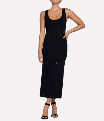 Image of a midi black knit dress, with thick spaghetti strap, u neckline, laser cut out details. Bra friendly, beach ware, little black dress, comfortable, thrown on and go. 