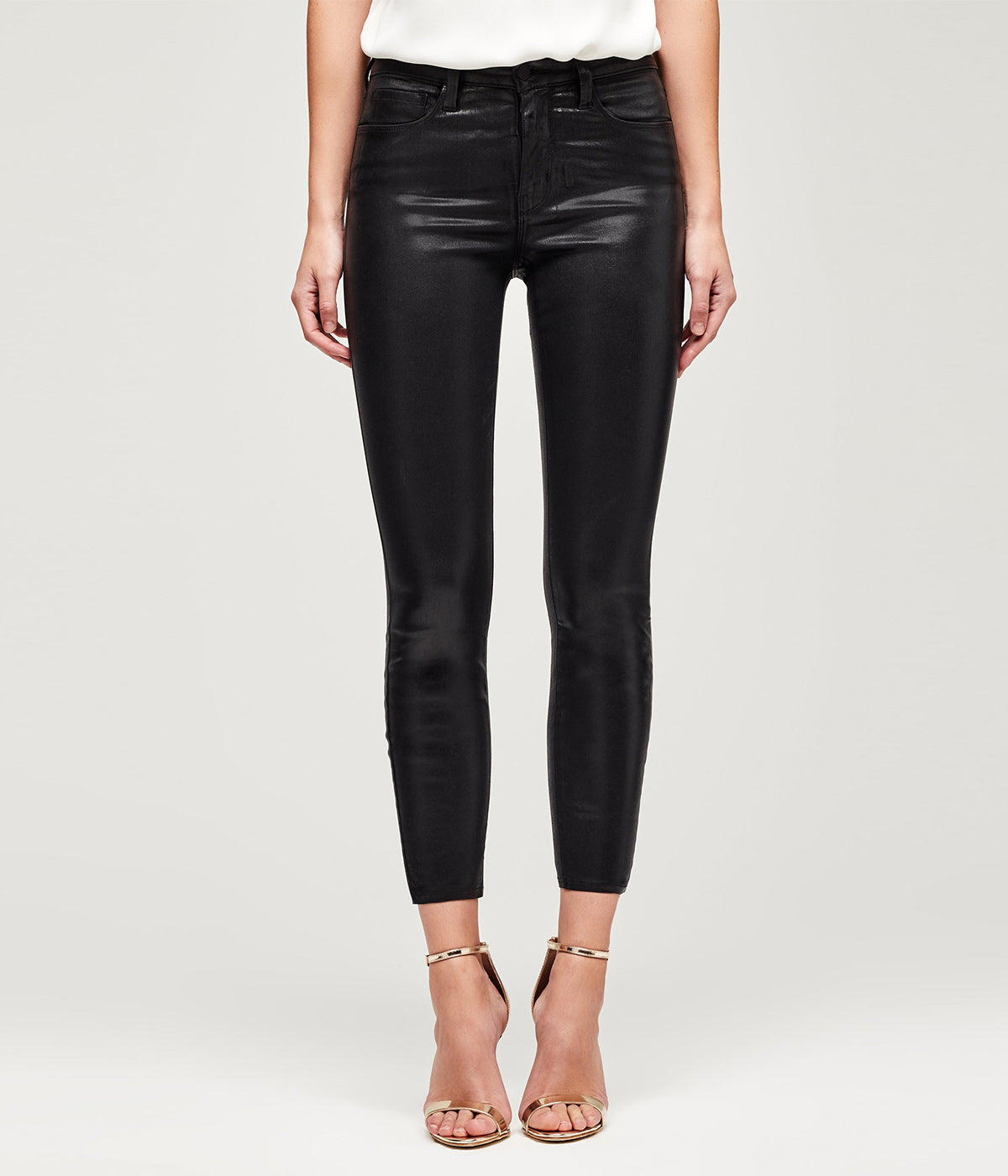 Black coated denim jean with a subtle sheen, featuring a tapered leg and contoured waistband for a flattering fit. The lightweight coating adds a sophisticated shine, enhancing the jean’s sleek, modern look
