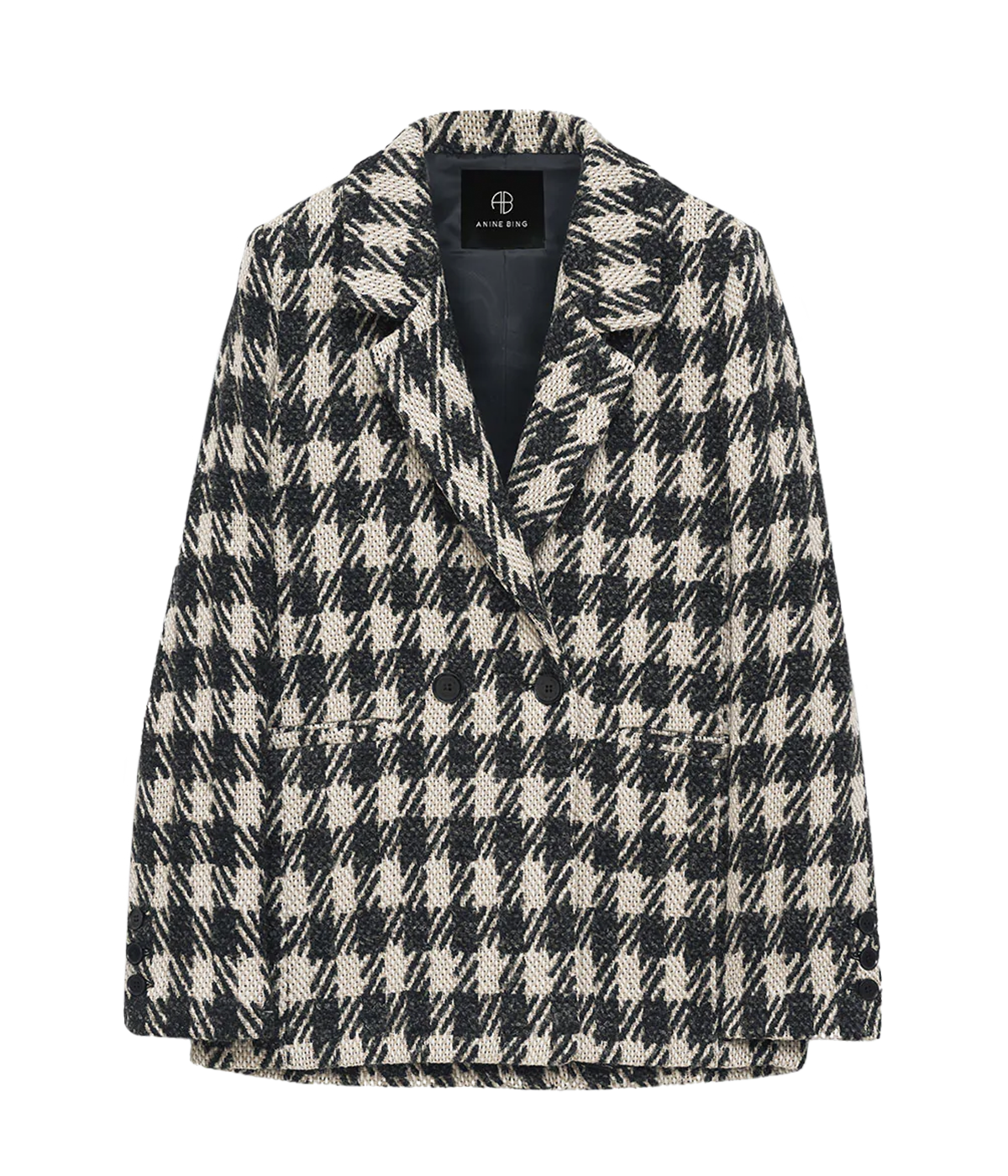 Image of a over sized blazer, with a black and tan plaid pattern with alternating texture.  Featuring a lined interior, chest pocket, three button cuff and double button front closure. 