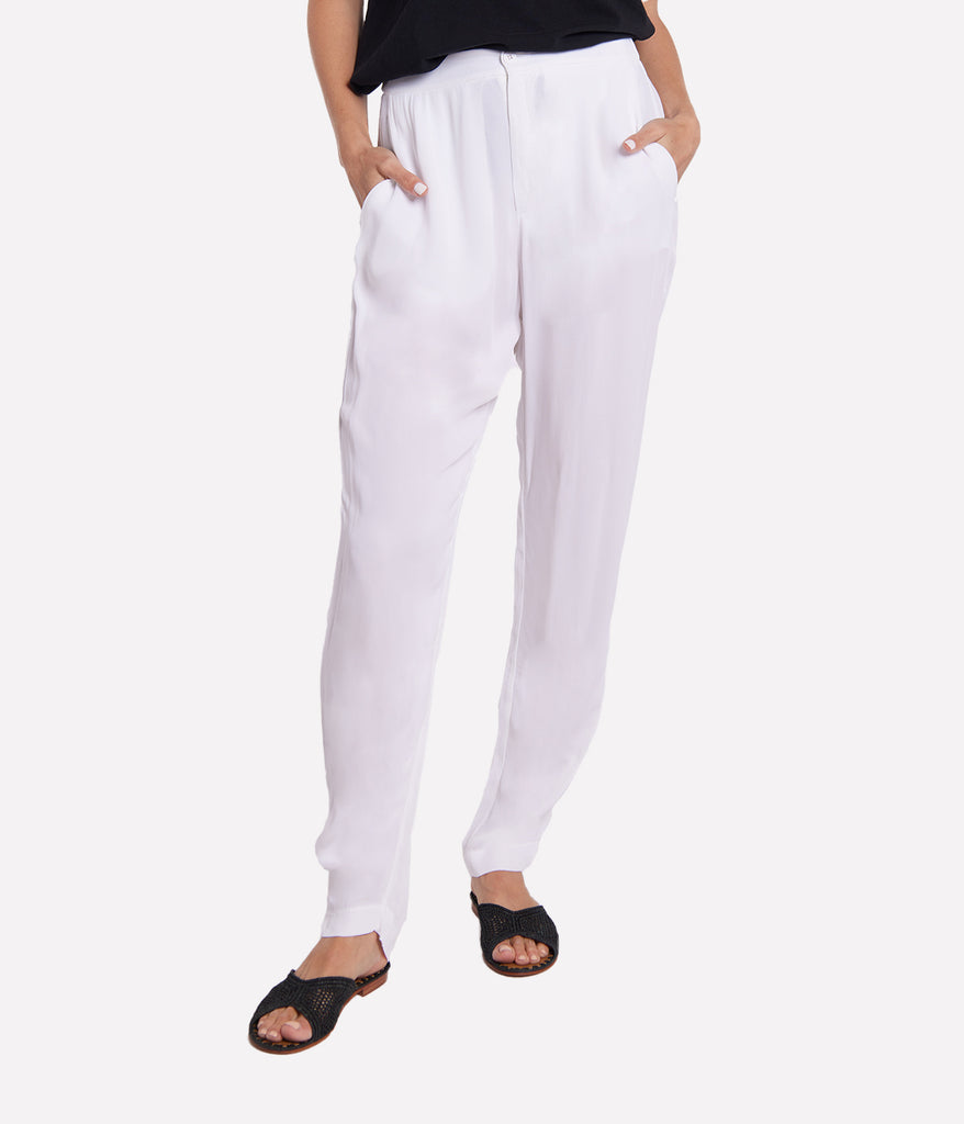 Image of full length white straight leg viscose trouser, featuring an elasticated waistband, button and fly fastening, front darts, side pockets and cuff at hem. 