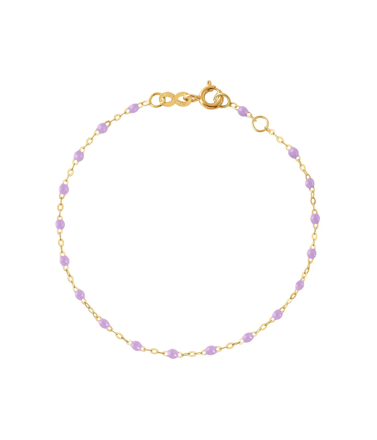 A gold bracelet with colourful resin jewels, styled for a chic and minimalist jewellery look