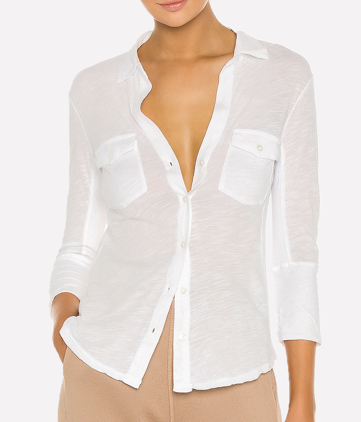 James Perse lightweight slub Supima cotton shirt in white with a slim silhouette, cropped sleeves, and V-neckline, styled with high-rise denim.