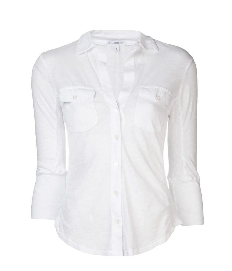 James Perse lightweight slub Supima cotton shirt in white with a slim silhouette, cropped sleeves, and V-neckline, styled with high-rise denim.