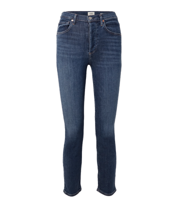 Image of a high-rise and slim-leg dark denim wash jean, with vintage inspired whiskering, cuffed hem, button and zip closure and gold hardware.